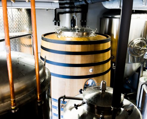 Vancouver Brewery Tours Inc. -Foudre and Fermentation Tanks in the brewhouse at Brassneck Brewery